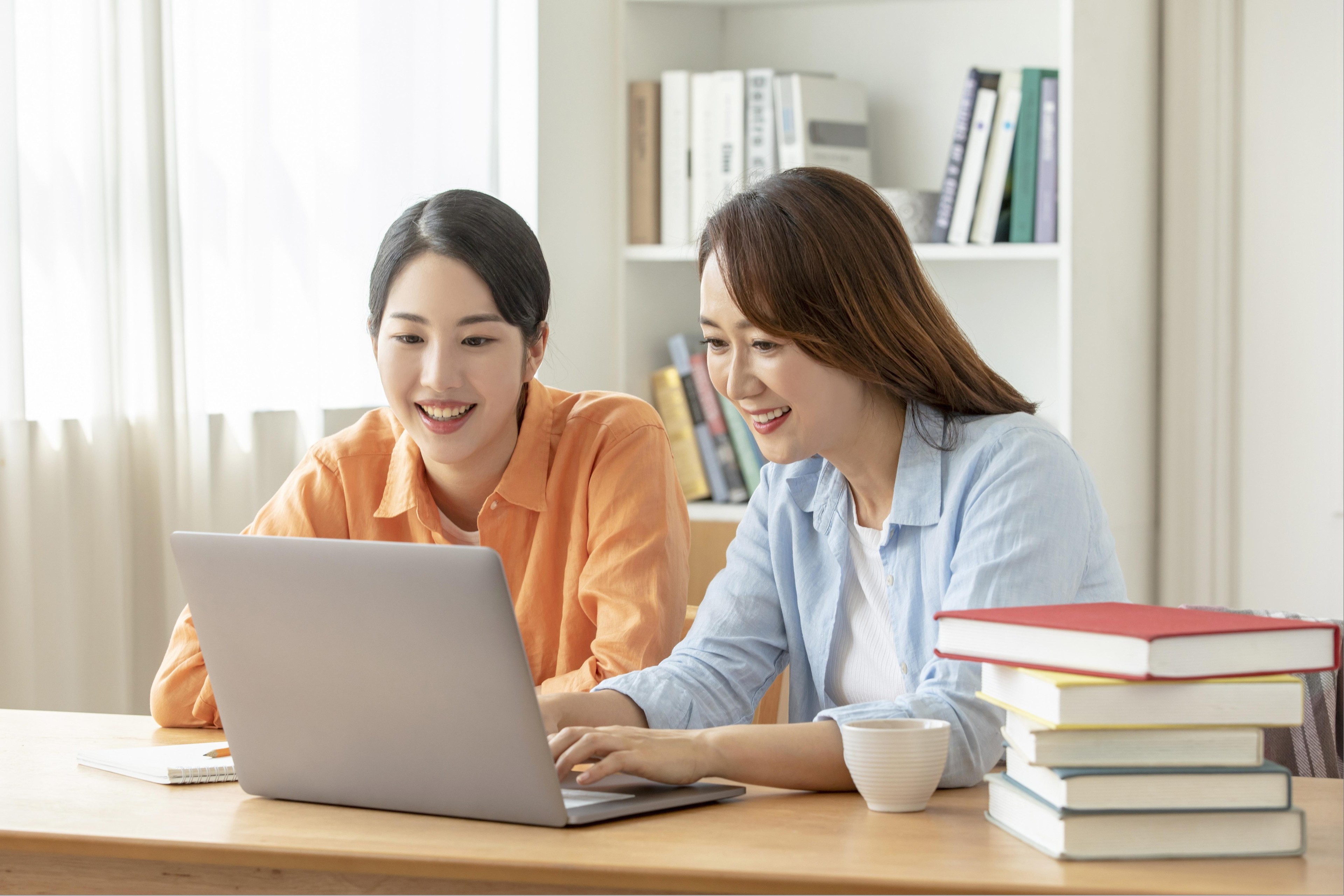 노트북 화면을 함께 확인하는 두 사람
