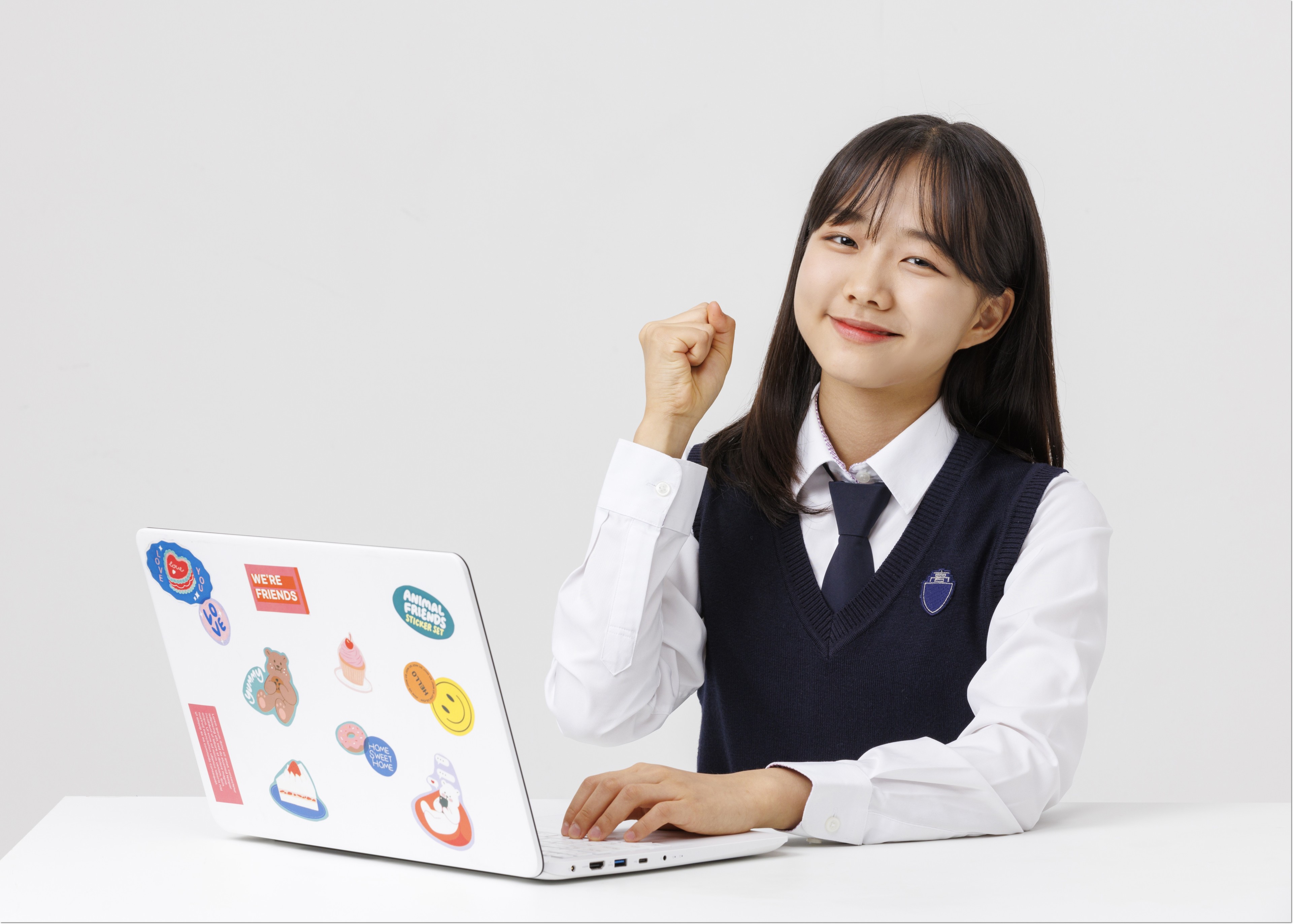 노트북과 교재 앞에서 생각하는 학생